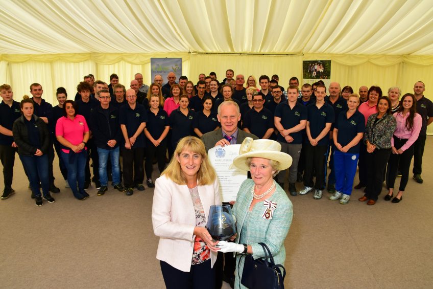 David & Helen Brass receive their award from Claire Hensman, Cumbria s Lord Lieutenant with staff helping celebrate.