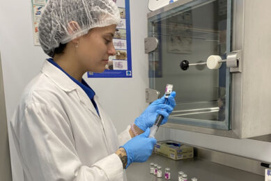 Trained hatchery staff preparing a vaccine solution to be injected in-ovo. After reconstitution, the vaccine bag is released to the transfer room using the dedicated transfer hatch. Photo: Ceva